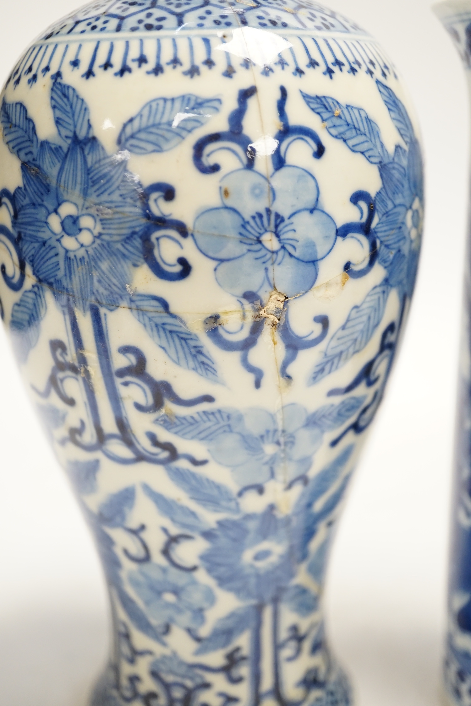 Two early 20th century Chinese blue and white vases, one restored, 23cm